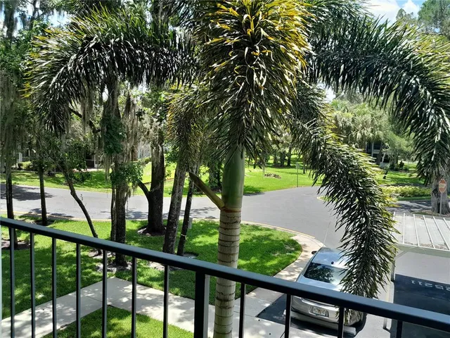 a view of a workspace with furniture and a lamp