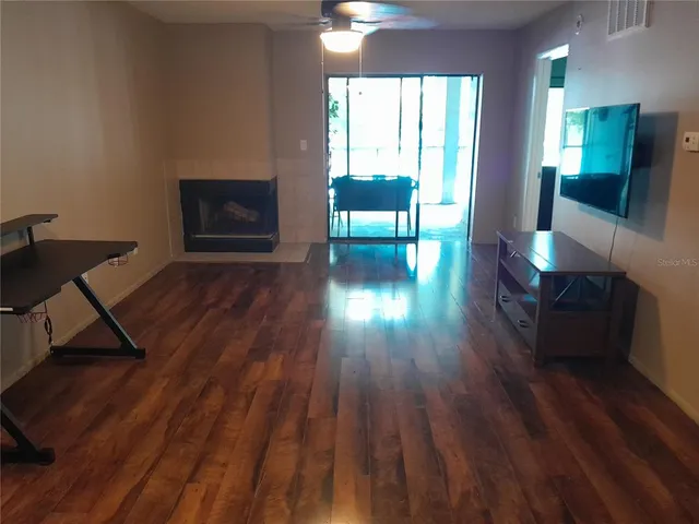 a kitchen with a sink cabinets and wooden floor