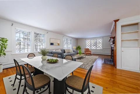 a view of empty room with wooden floor and fireplace