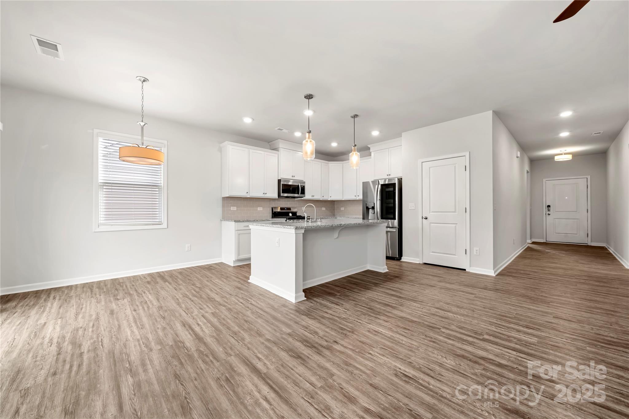 7184 Indigo Way Denver, NC 28037 - Photo 12 of 41 a view of kitchen with wooden floor and window