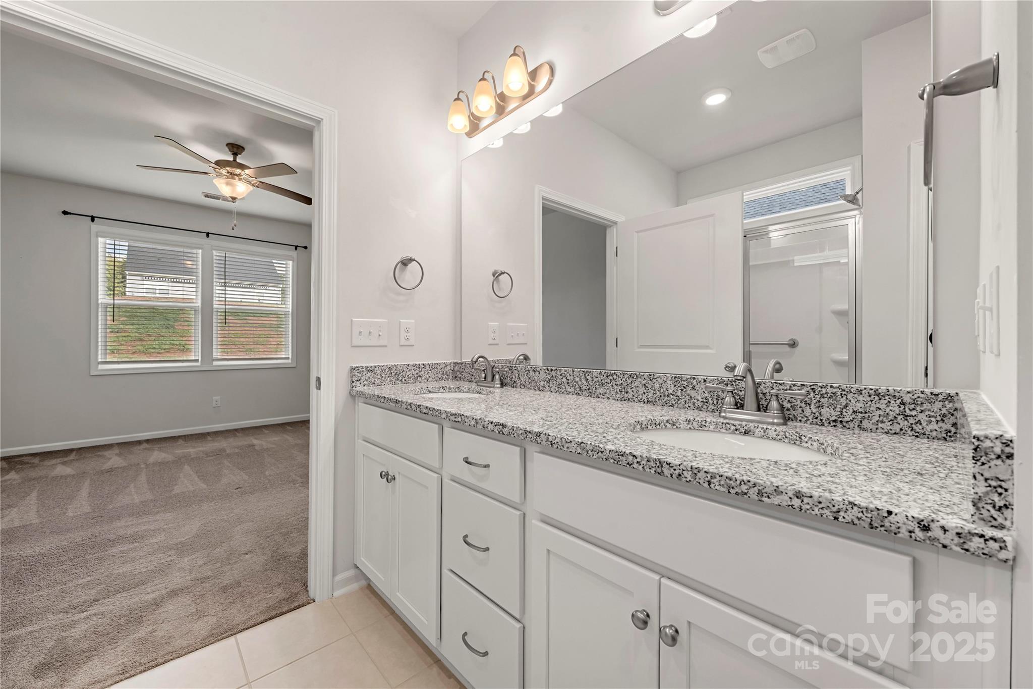 7184 Indigo Way Denver, NC 28037 - Photo 17 of 41 a bathroom with a granite countertop double vanity sink and a mirror