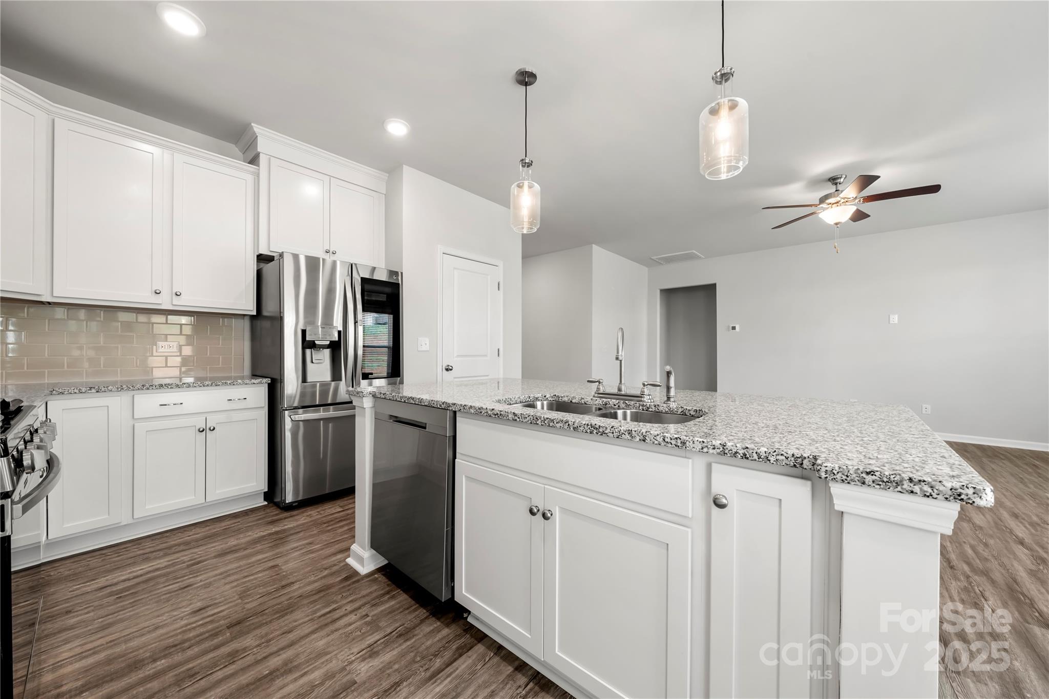 7184 Indigo Way Denver, NC 28037 - Photo 4 of 41 a kitchen with refrigerator cabinets and wooden floor