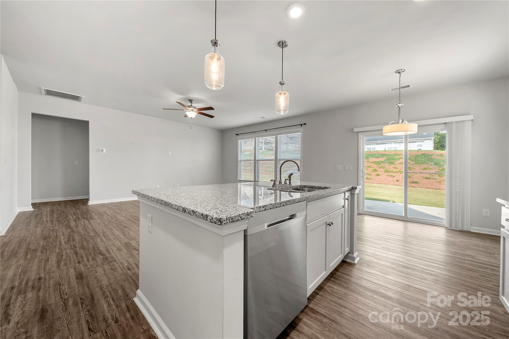 7184 Indigo Way Denver, NC 28037 - Photo 8 of 41 a kitchen with granite countertop counter space a sink appliances and a large window