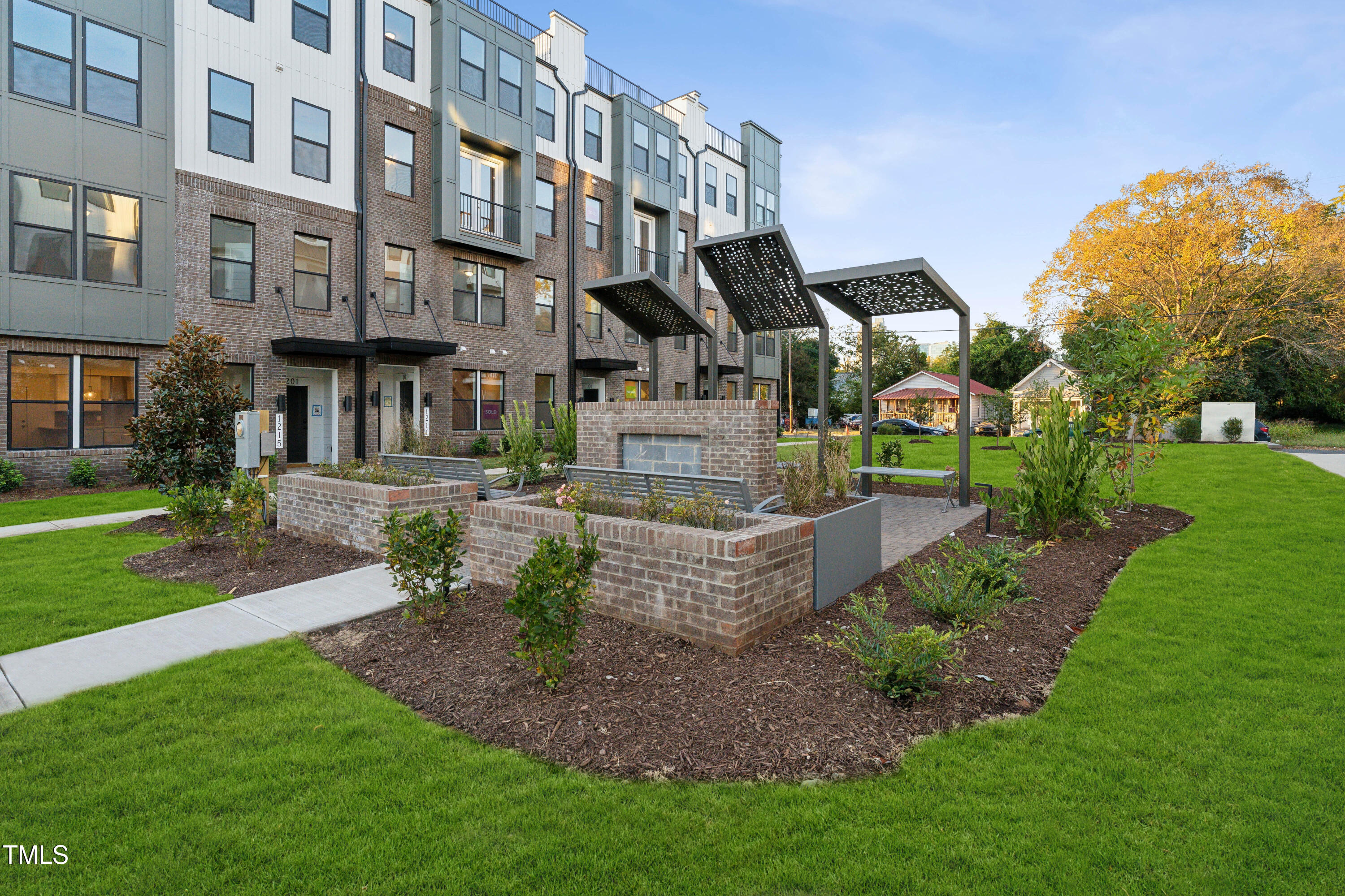 1232 South Person Street, Unit 101 Raleigh, NC 27601 - Photo 25 of 28 a front view of a building with a garden