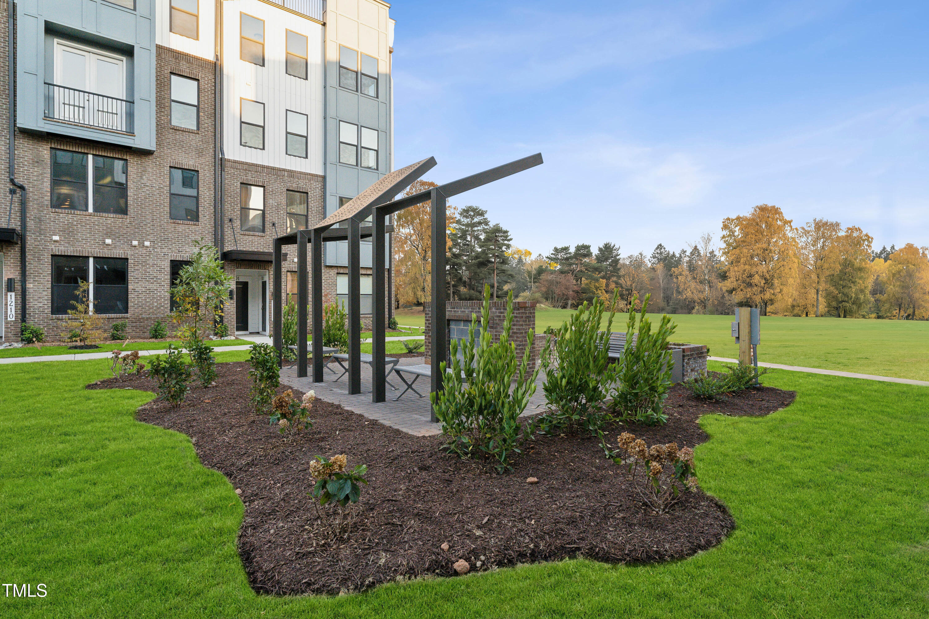 1232 South Person Street, Unit 101 Raleigh, NC 27601 - Photo 27 of 28 a view of a building with a yard