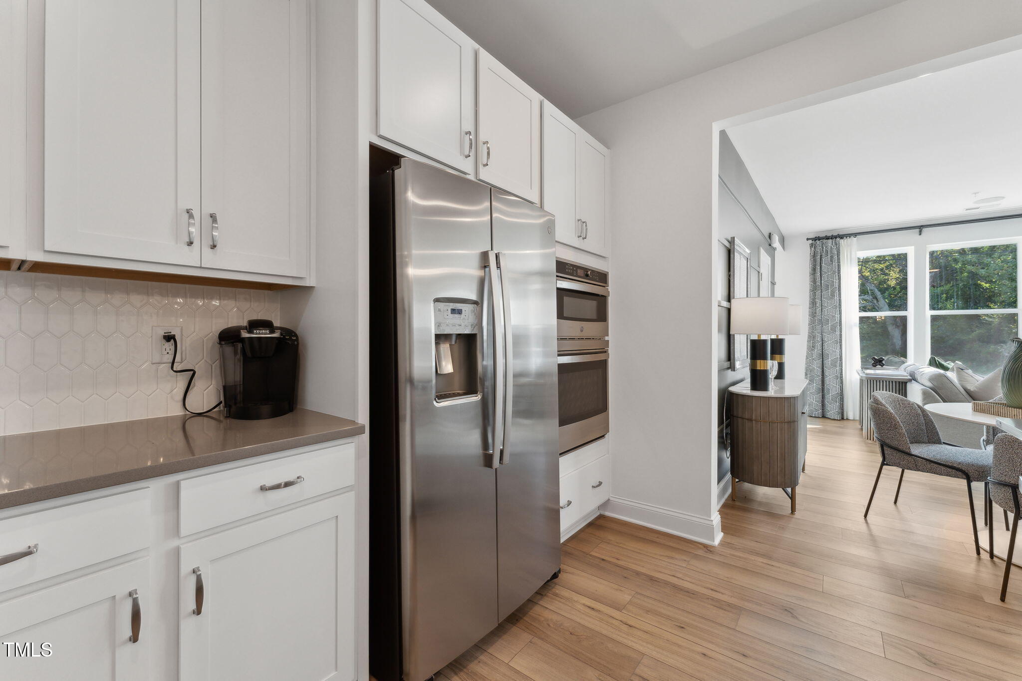 1232 South Person Street, Unit 101 Raleigh, NC 27601 - Photo 3 of 28 a kitchen with stainless steel appliances a refrigerator sink and cabinets