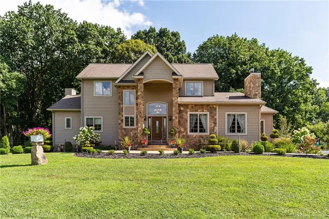 a front view of house with yard outdoor seating and green space