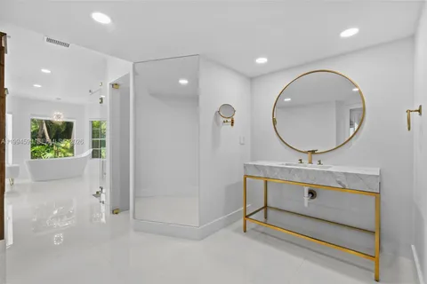 a bathroom with a sink mirror and vanity