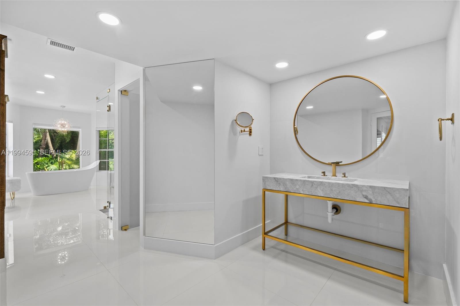 6801 Southwest 126th Terrace Pinecrest, FL 33156 - Photo 11 of 30 a bathroom with a sink mirror and vanity