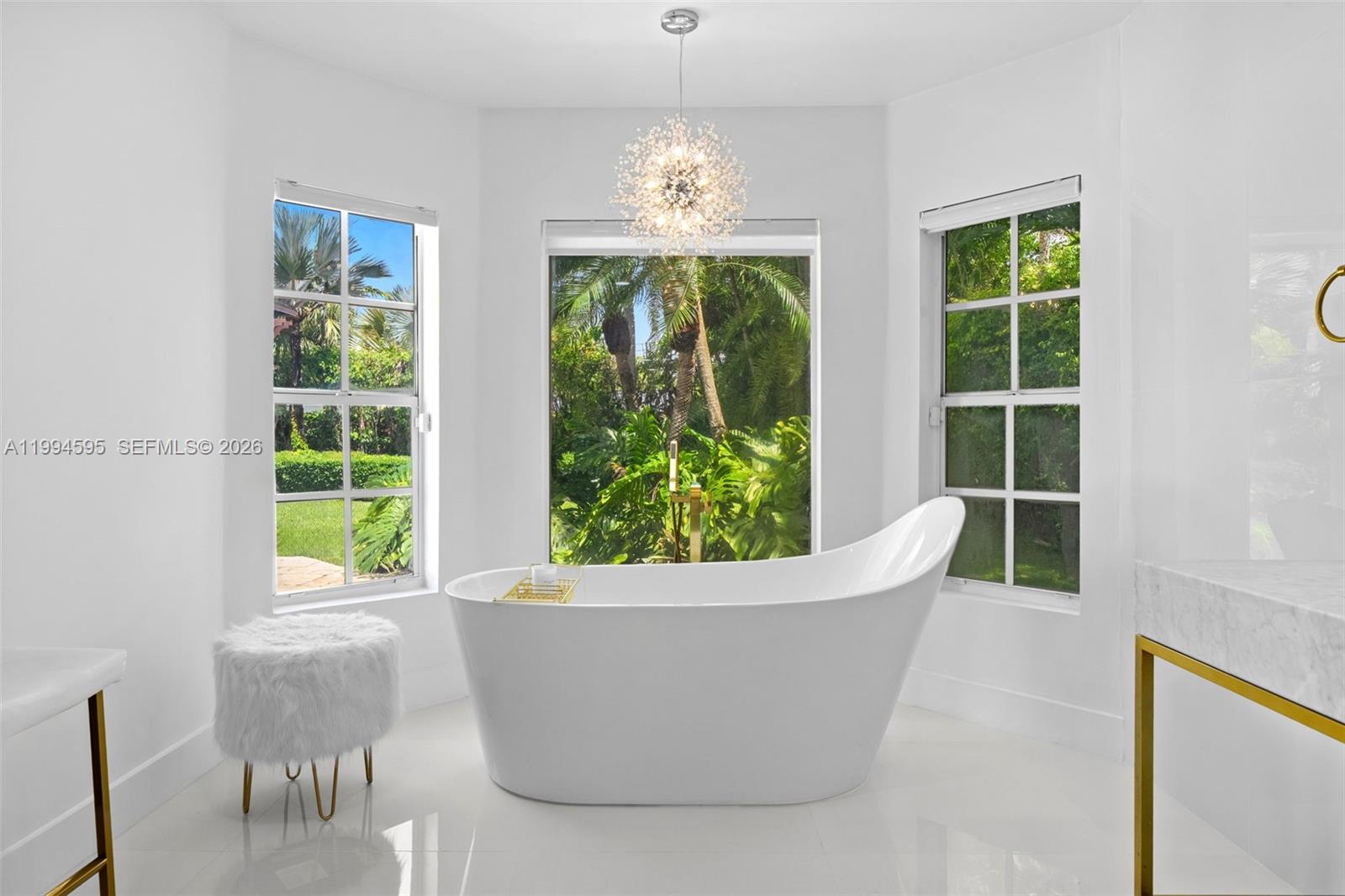 6801 Southwest 126th Terrace Pinecrest, FL 33156 - Photo 12 of 30 a white bath tub sitting in a window