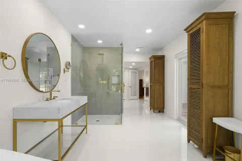 a bathroom with a sink a mirror and a shower
