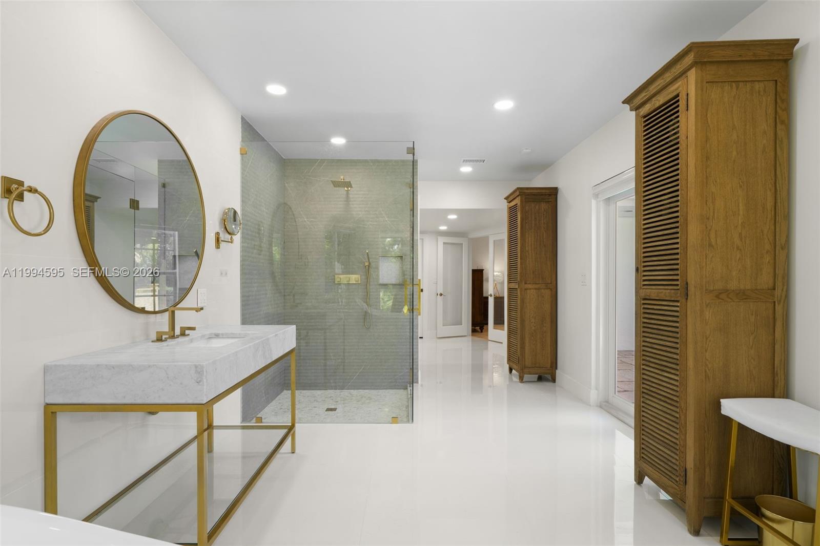 6801 Southwest 126th Terrace Pinecrest, FL 33156 - Photo 13 of 30 a bathroom with a sink a mirror and a shower