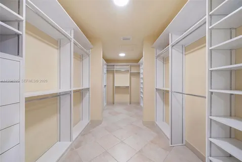 a view of a hallway with closet and bathroom