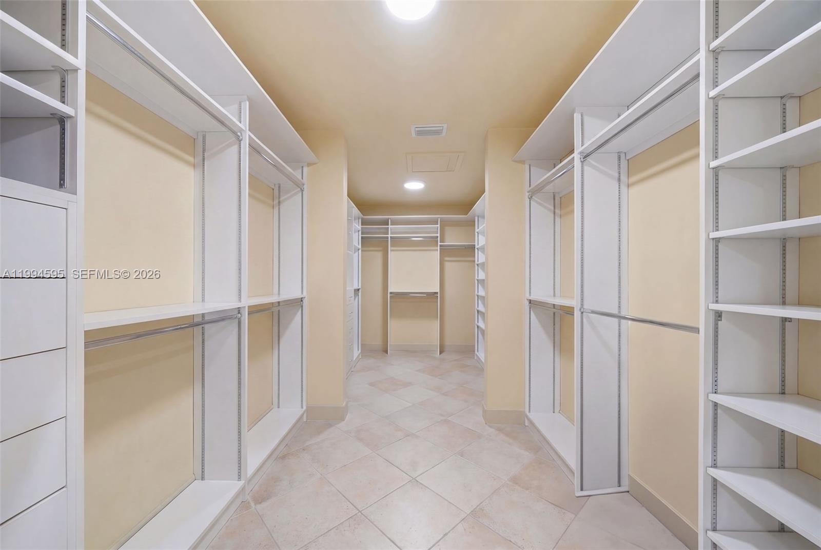 6801 Southwest 126th Terrace Pinecrest, FL 33156 - Photo 14 of 30 a view of a hallway with closet and bathroom