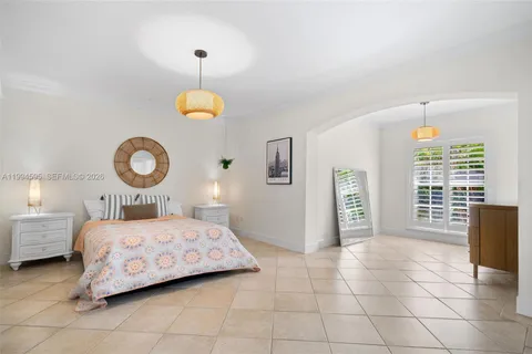 a bedroom with a bed and a table