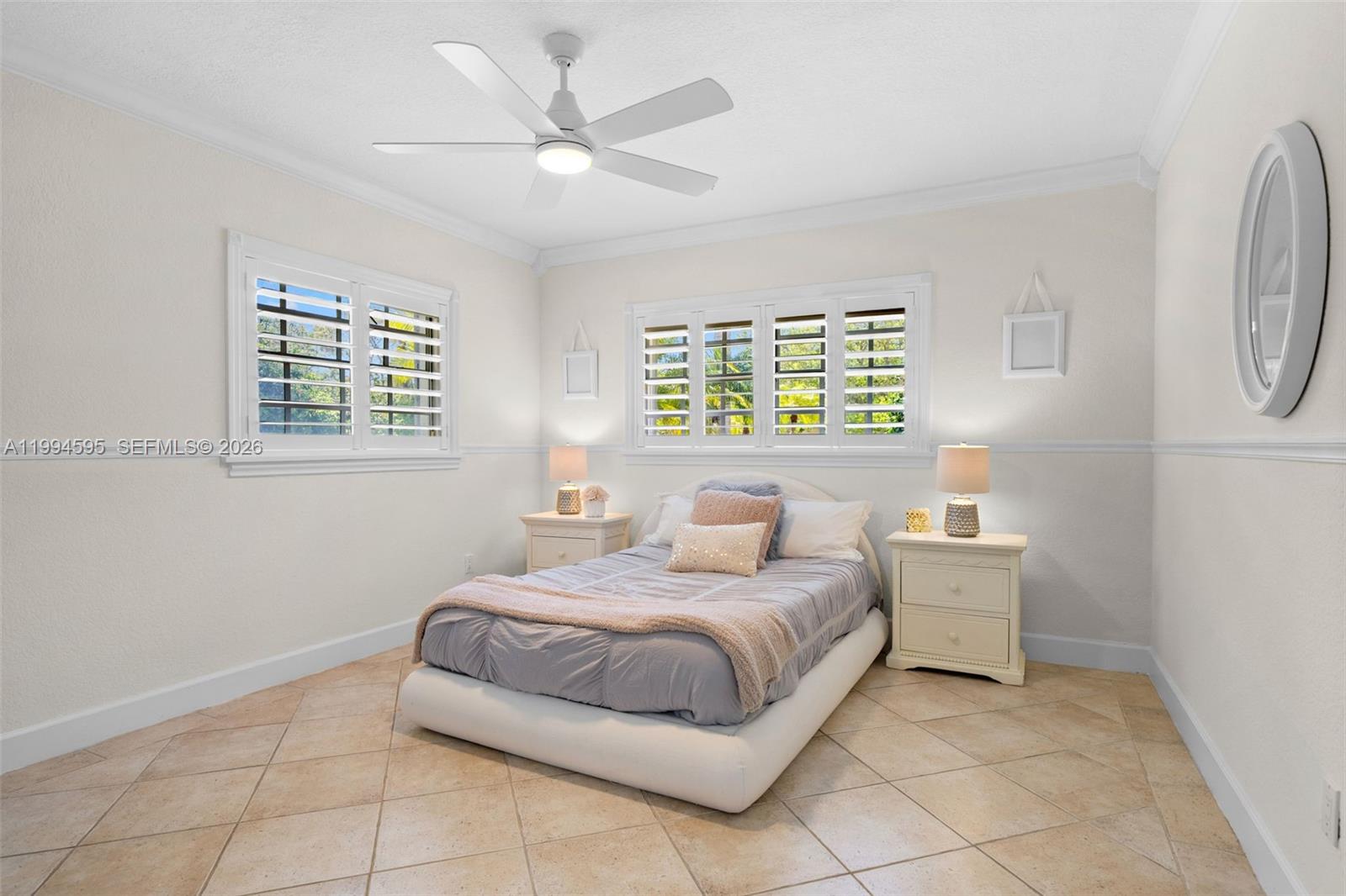 6801 Southwest 126th Terrace Pinecrest, FL 33156 - Photo 17 of 30 a bedroom with a bed and a window