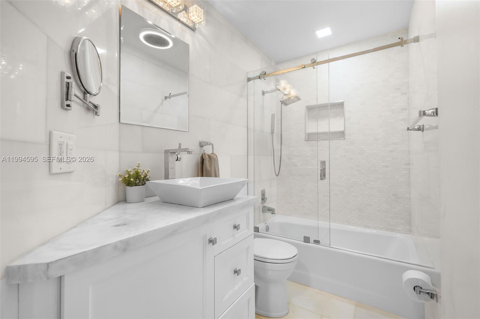6801 Southwest 126th Terrace Pinecrest, FL 33156 - Photo 19 of 30 a bathroom with a sink toilet and shower