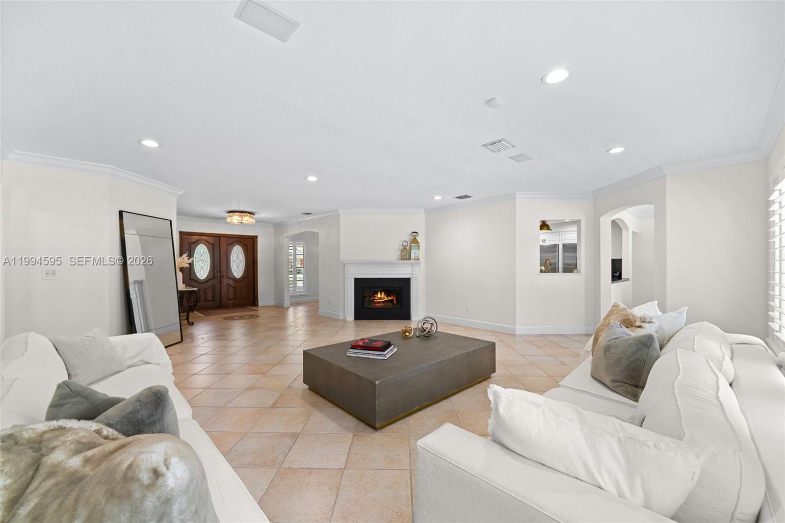 6801 Southwest 126th Terrace Pinecrest, FL 33156 - Photo 2 of 30 a living room with furniture and a fireplace