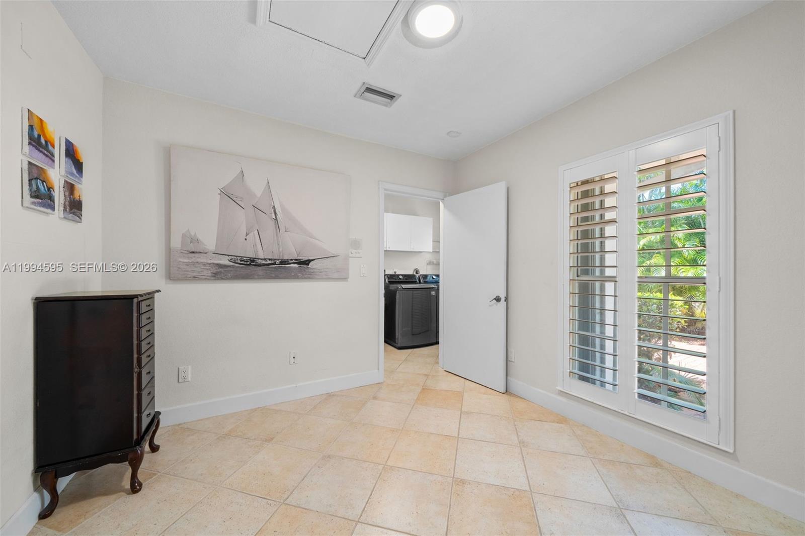 6801 Southwest 126th Terrace Pinecrest, FL 33156 - Photo 21 of 30 a view of a kitchen with furniture and an empty room