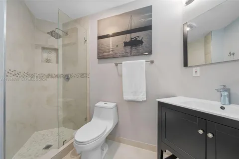 a bathroom with a toilet sink and shower