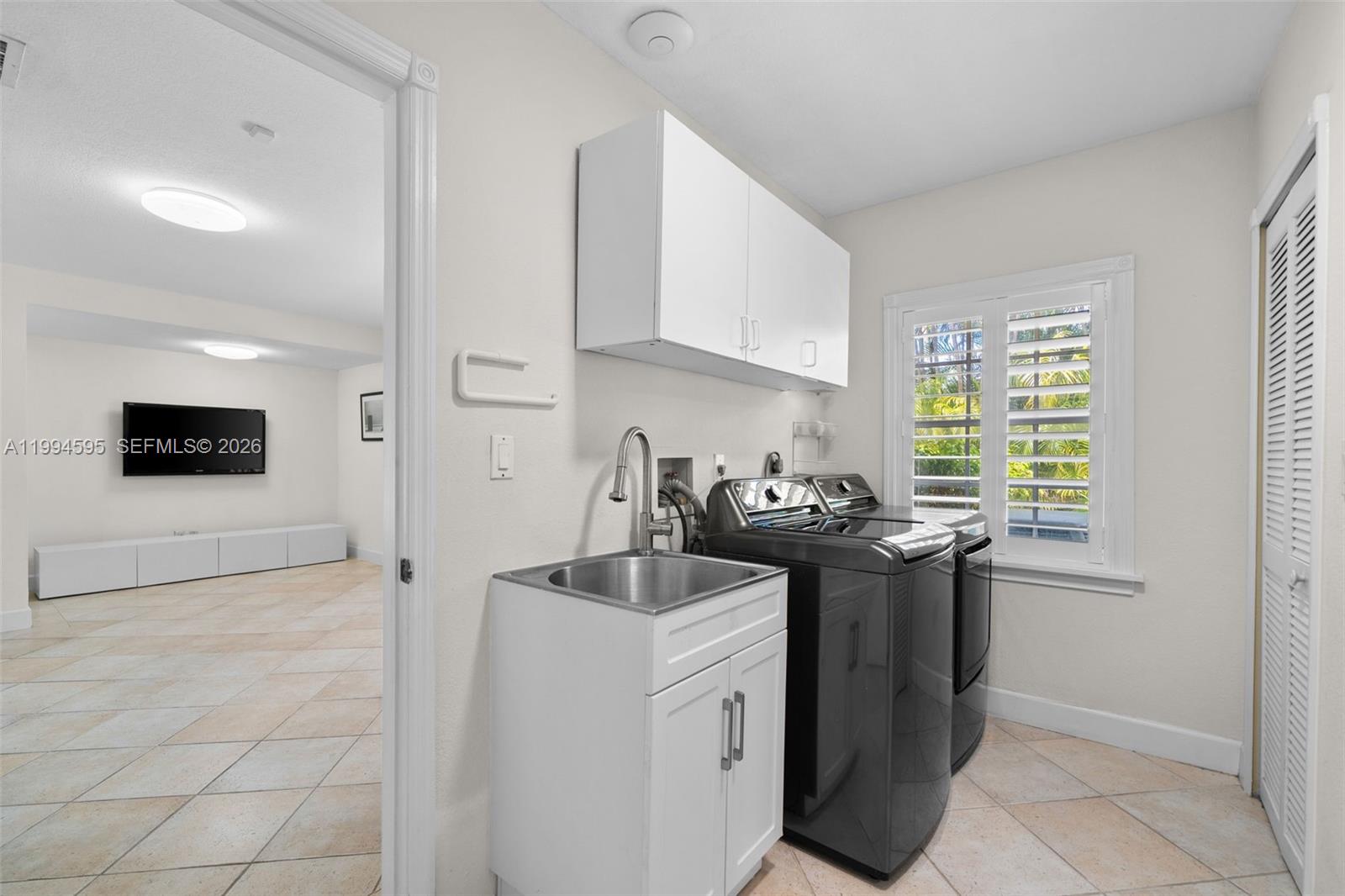 6801 Southwest 126th Terrace Pinecrest, FL 33156 - Photo 24 of 30 a kitchen with a sink stove and cabinets