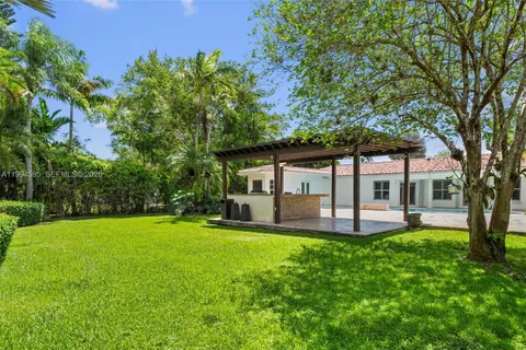 a view of a house with a yard and sitting area