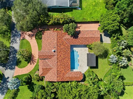 an aerial view of a house with a yard