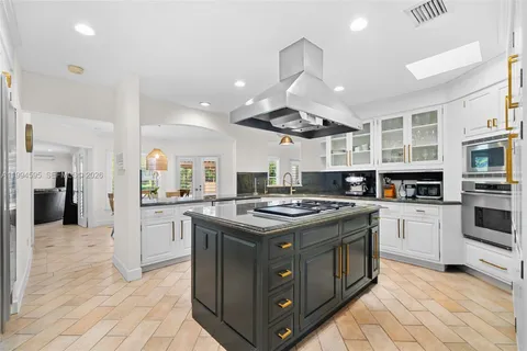 a kitchen with stainless steel appliances granite countertop a stove and a sink