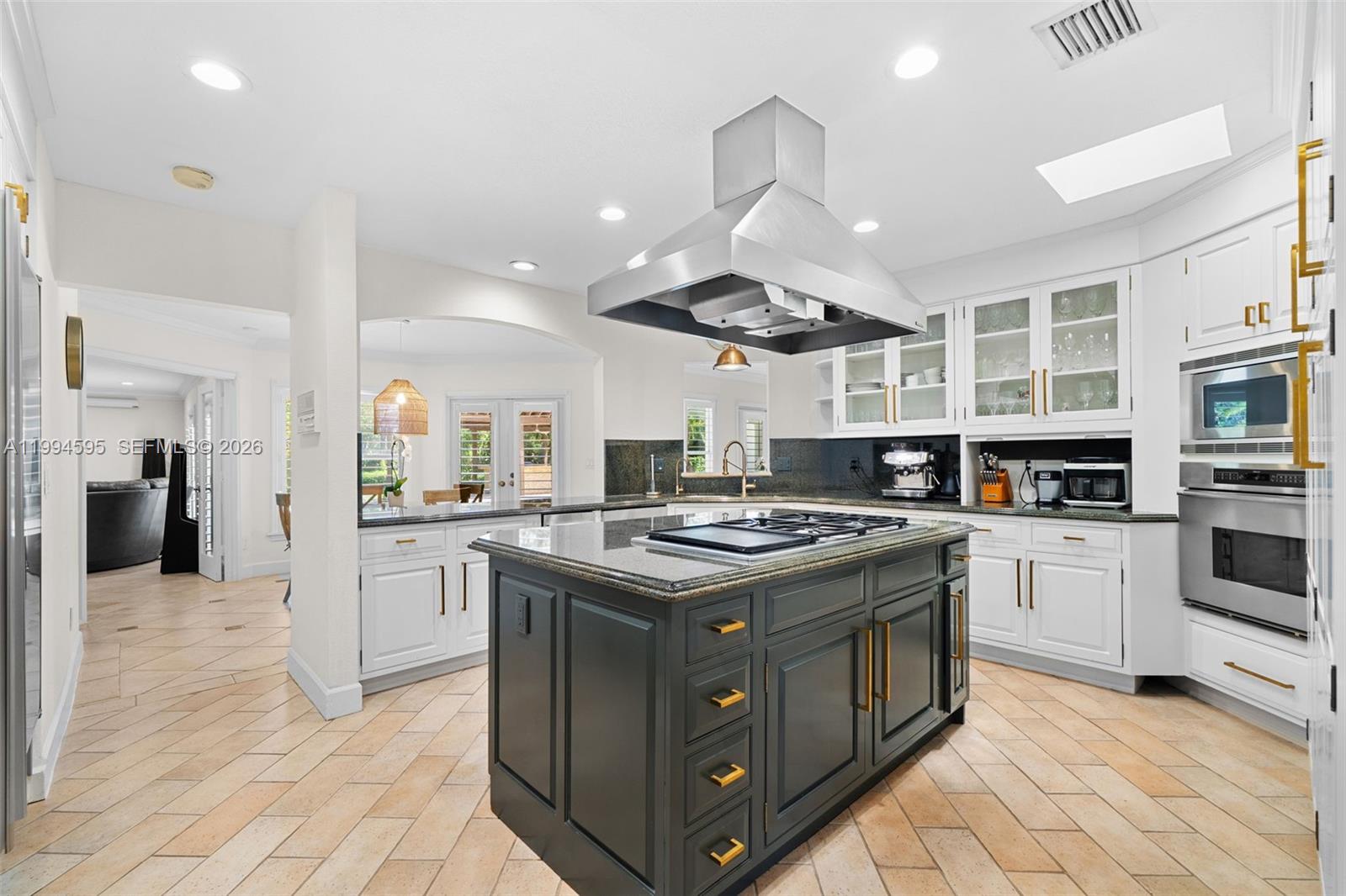 6801 Southwest 126th Terrace Pinecrest, FL 33156 - Photo 5 of 30 a kitchen with stainless steel appliances granite countertop a stove and a sink