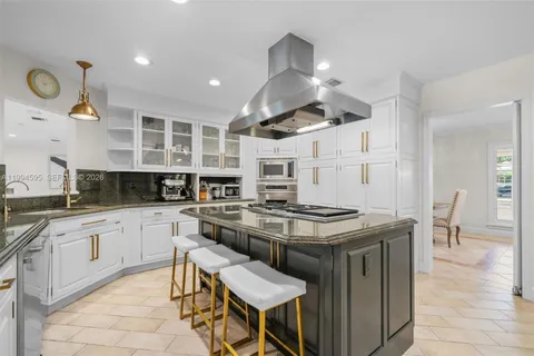 a kitchen with stainless steel appliances granite countertop a stove and a sink