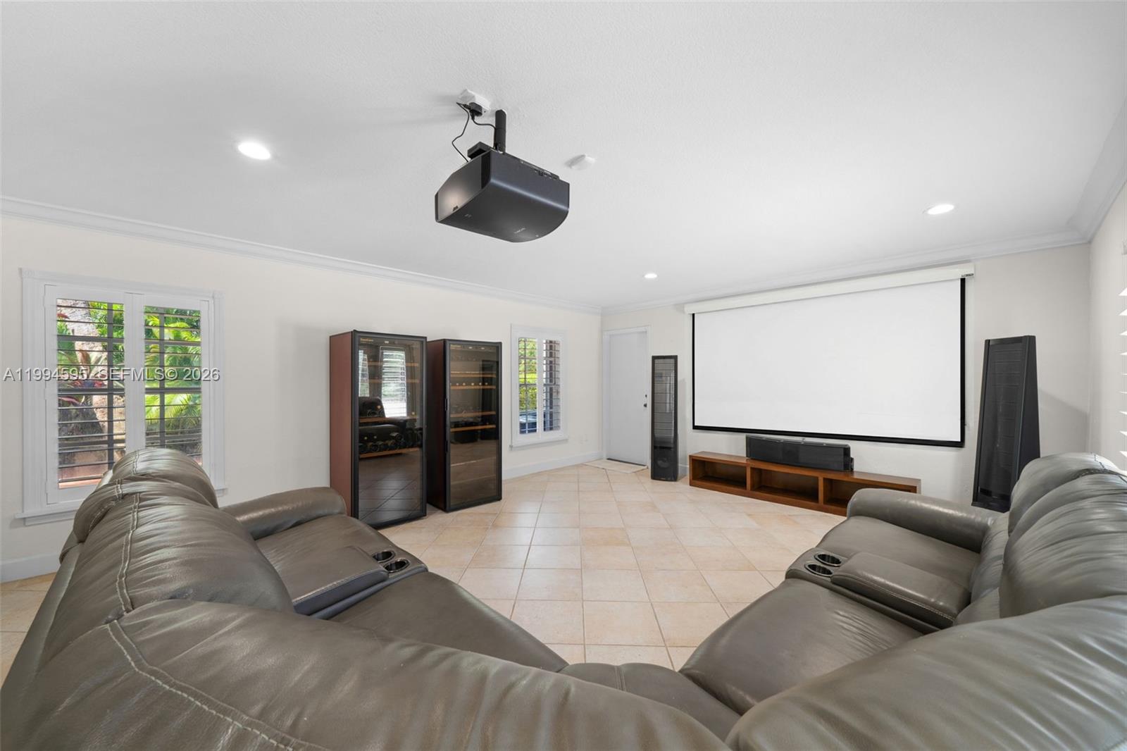 6801 Southwest 126th Terrace Pinecrest, FL 33156 - Photo 8 of 30 a living room with furniture and a flat screen tv