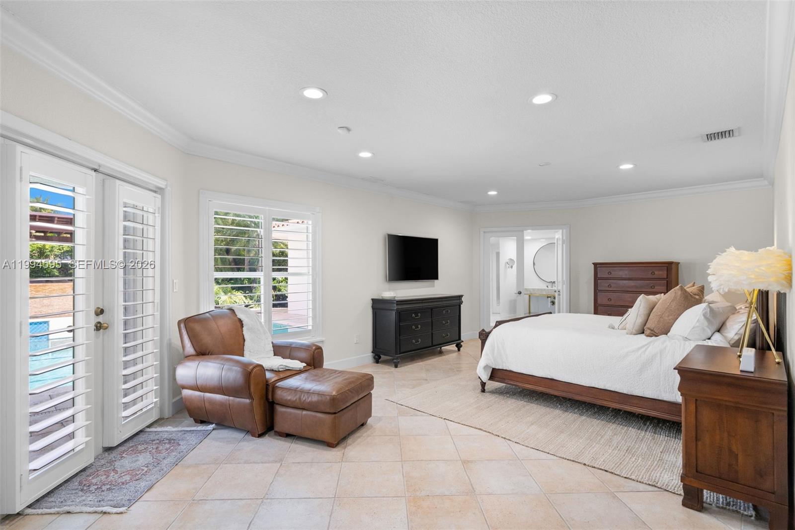 6801 Southwest 126th Terrace Pinecrest, FL 33156 - Photo 9 of 30 a bedroom with a bed and a couch