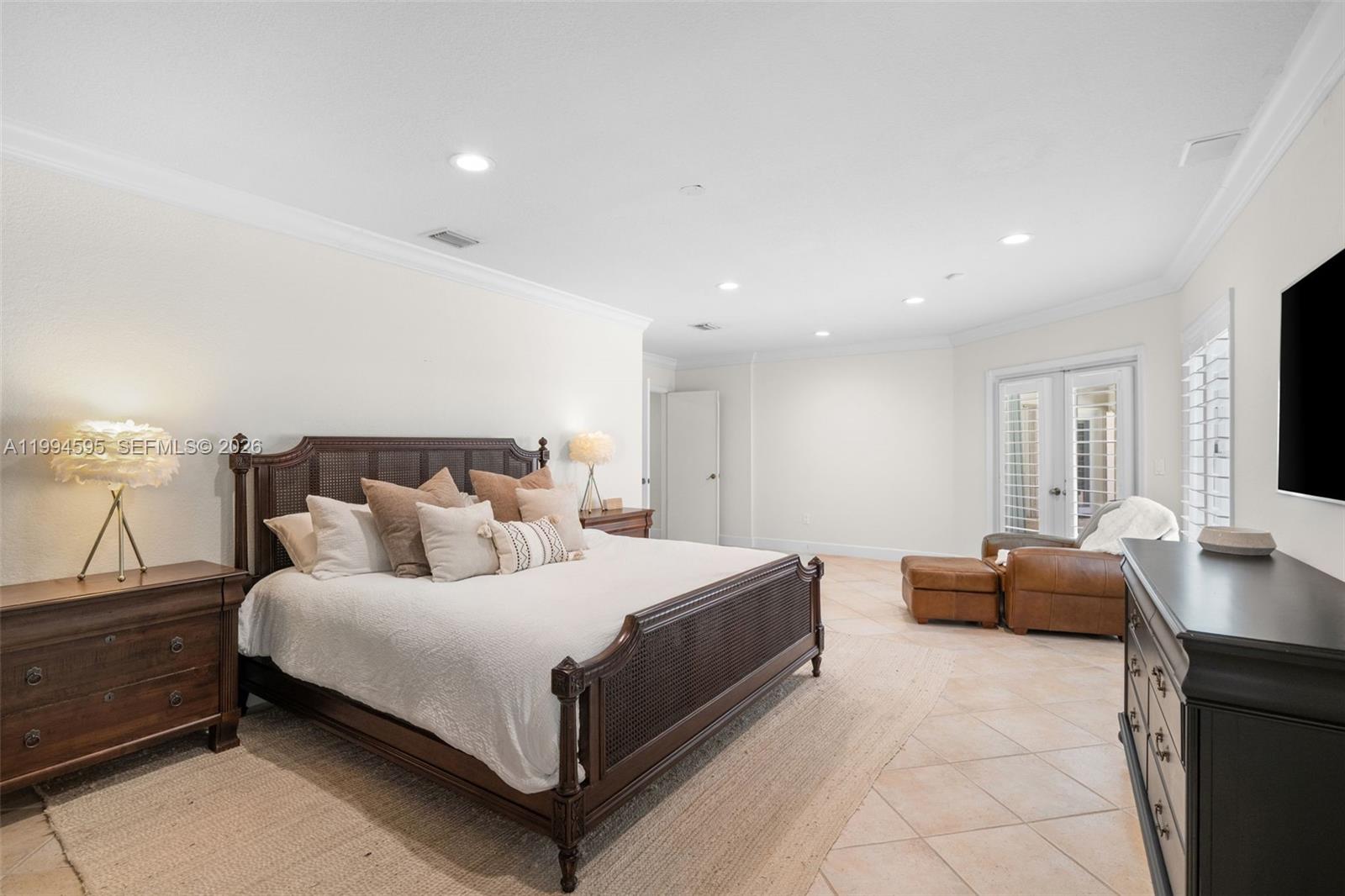 6801 Southwest 126th Terrace Pinecrest, FL 33156 - Photo 10 of 30 a bedroom with a bed and furniture