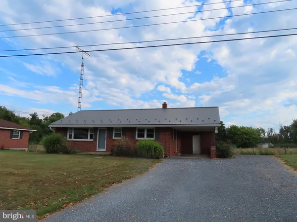 a view of a house with a yard and plants