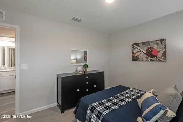 a bedroom with a bed and a table