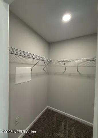 an empty room with a hard wood floor and a ceiling fan