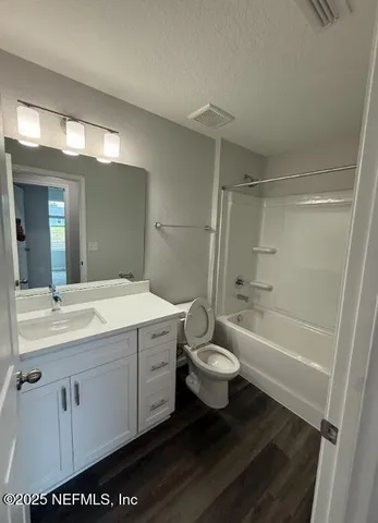 a view of storage and utility room with wooden floor
