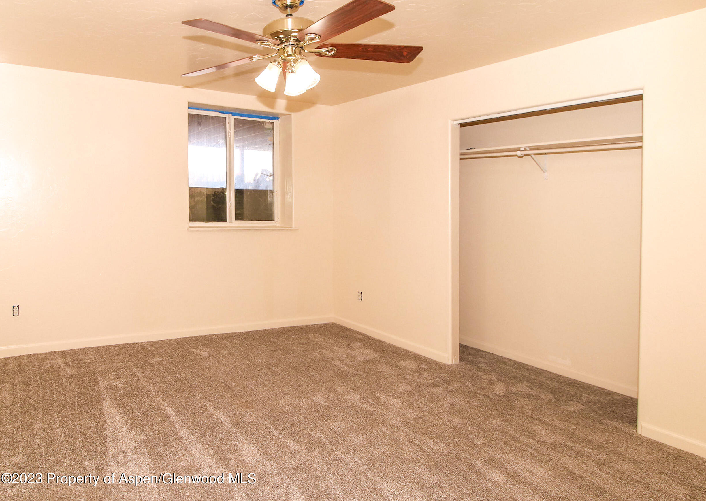 236 First Mesa Drive Silt, CO 81652 - Photo 38 of 41 an empty room with a window and a ceiling fan