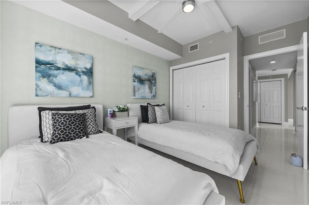 3000 Oasis Grand Boulevard, Unit 2007 Fort Myers, FL 33916 - Photo 28 of 45 a bedroom with double bed and wall painting