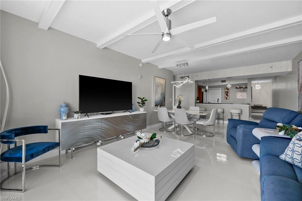 3000 Oasis Grand Boulevard, Unit 2007 Fort Myers, FL 33916 - Photo 33 of 45 a living room with furniture and a flat screen tv