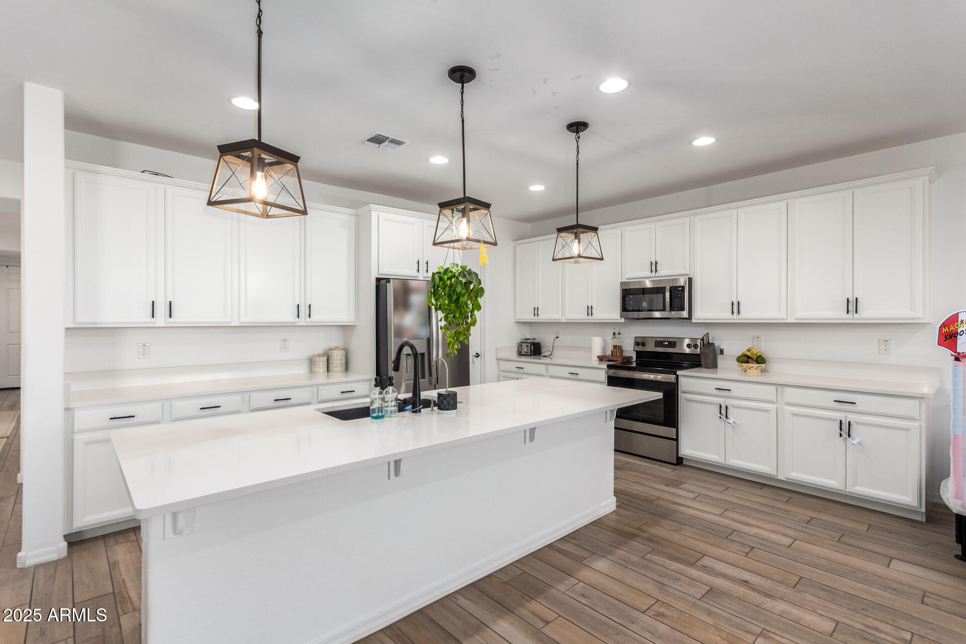 24608 Seed Road Florence, AZ 85132 - Photo 13 of 45 a kitchen with kitchen island white cabinets stainless steel appliances a sink and cabinets