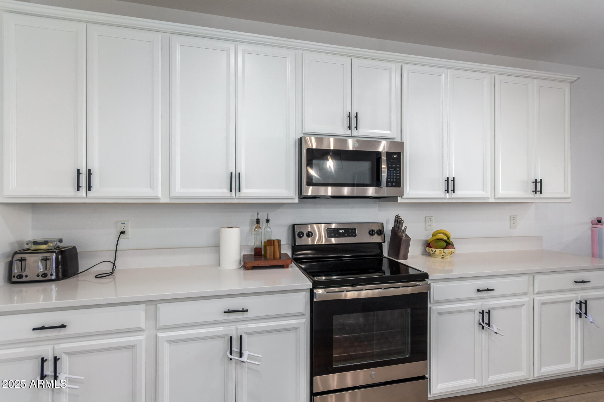 24608 Seed Road Florence, AZ 85132 - Photo 14 of 45 a kitchen with white cabinets and appliances