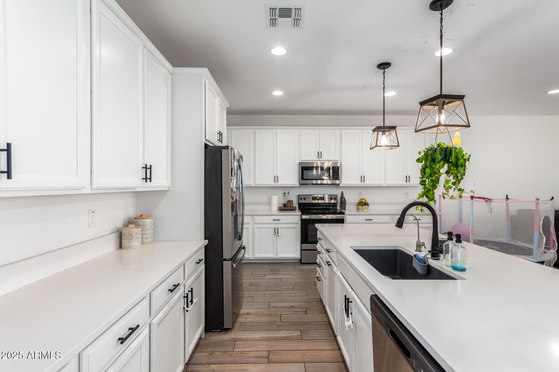 24608 Seed Road Florence, AZ 85132 - Photo 16 of 45 a kitchen with kitchen island a sink appliances and cabinets