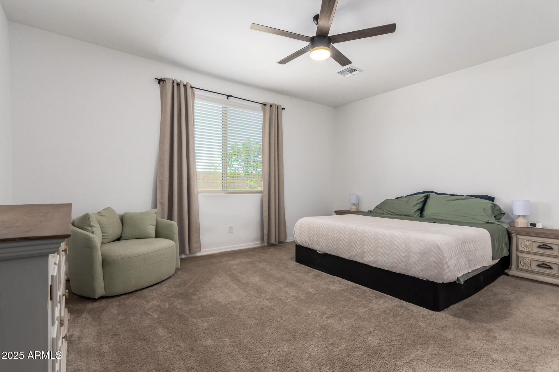 24608 Seed Road Florence, AZ 85132 - Photo 18 of 45 a spacious bedroom with a bed and a couch