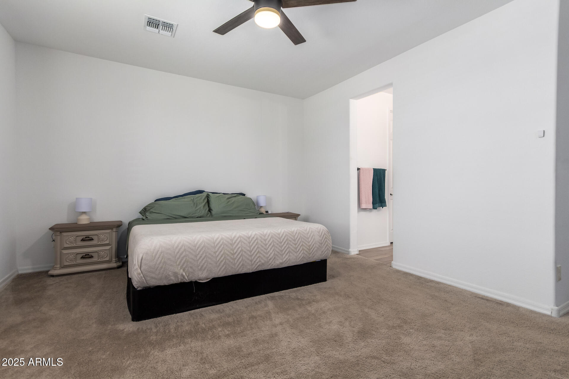 24608 Seed Road Florence, AZ 85132 - Photo 19 of 45 a bedroom with a bed and a ceiling fan