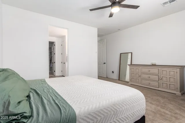 a bedroom with a bed and cabinets