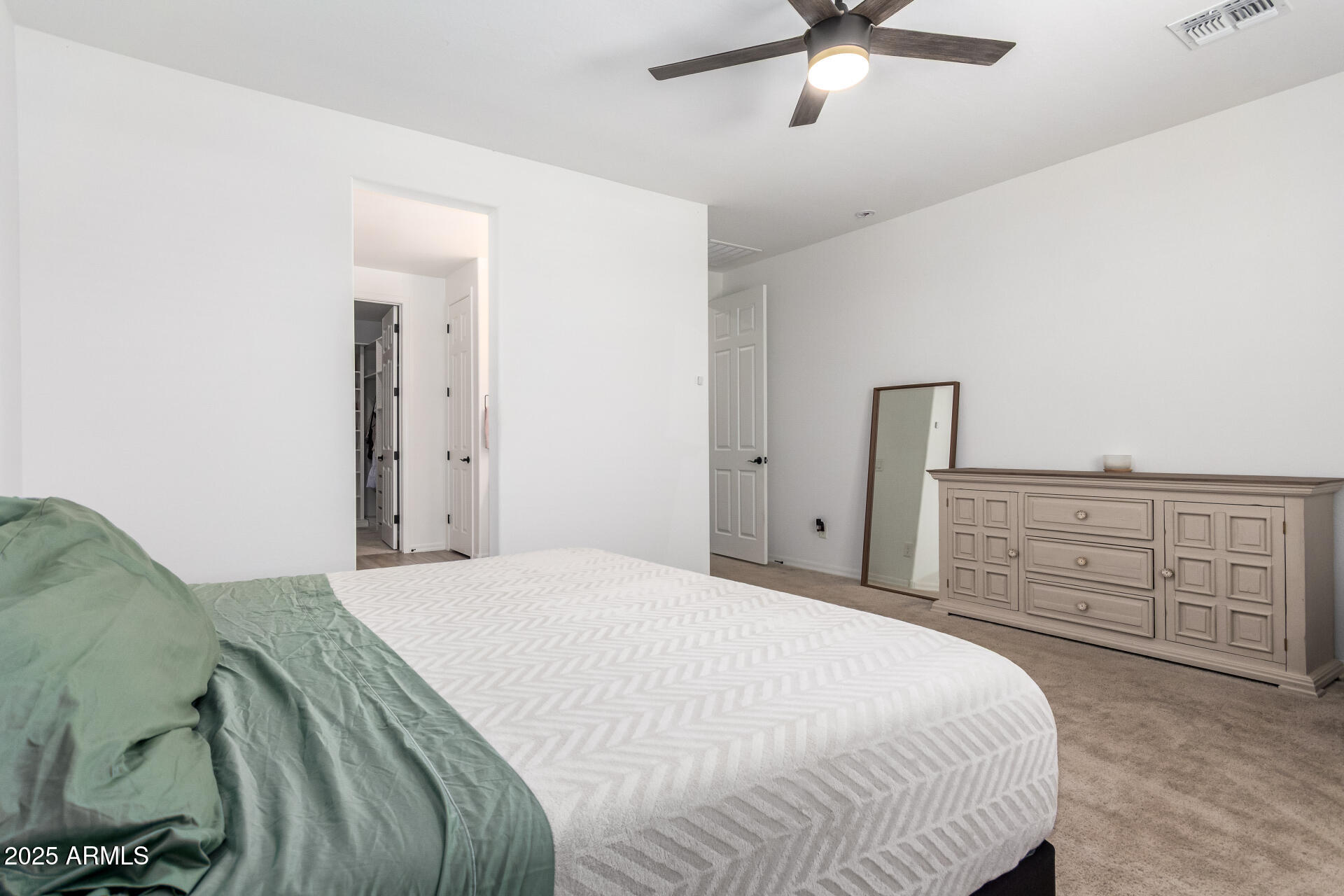24608 Seed Road Florence, AZ 85132 - Photo 20 of 45 a bedroom with a bed and cabinets