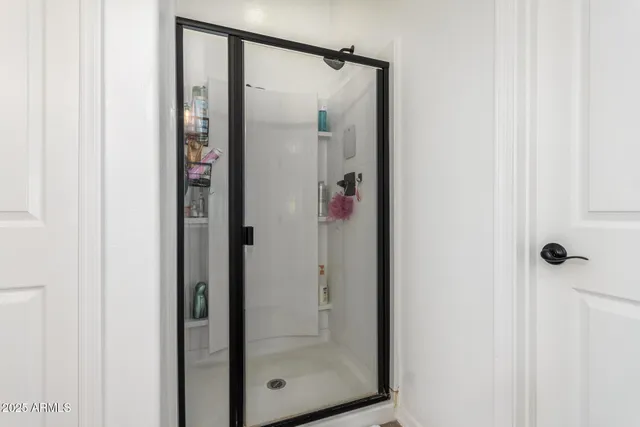 a bathroom with a glass shower door