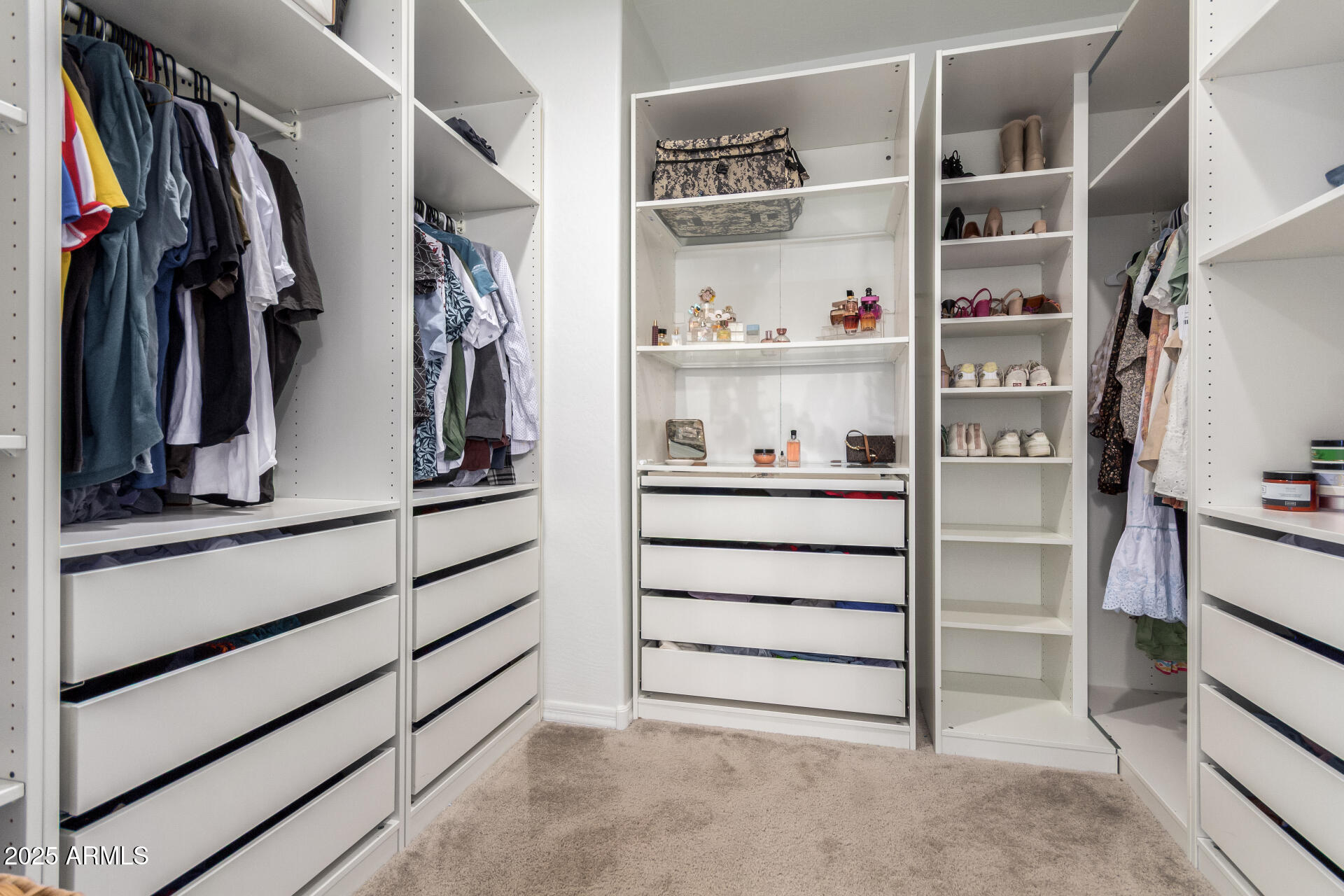 24608 Seed Road Florence, AZ 85132 - Photo 23 of 45 a view of walk in closet with clothes and shoes