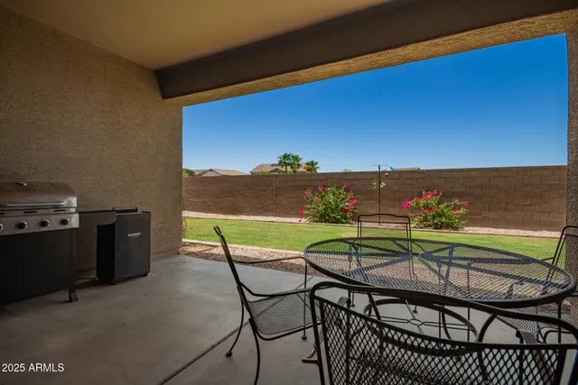 a view of a chairs and table in patio